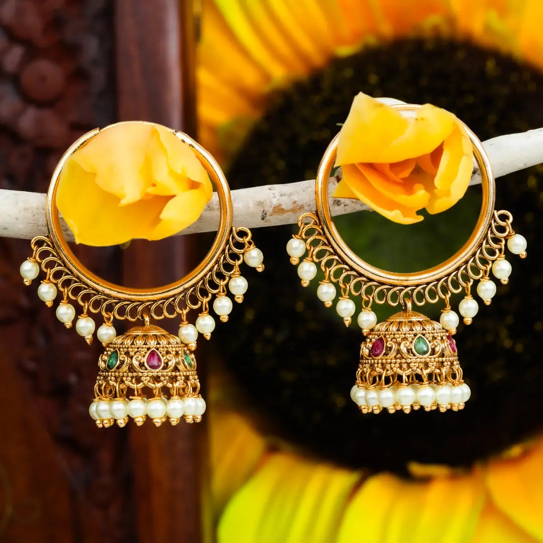 Gold earrings with yellow flowers on a sunflower background