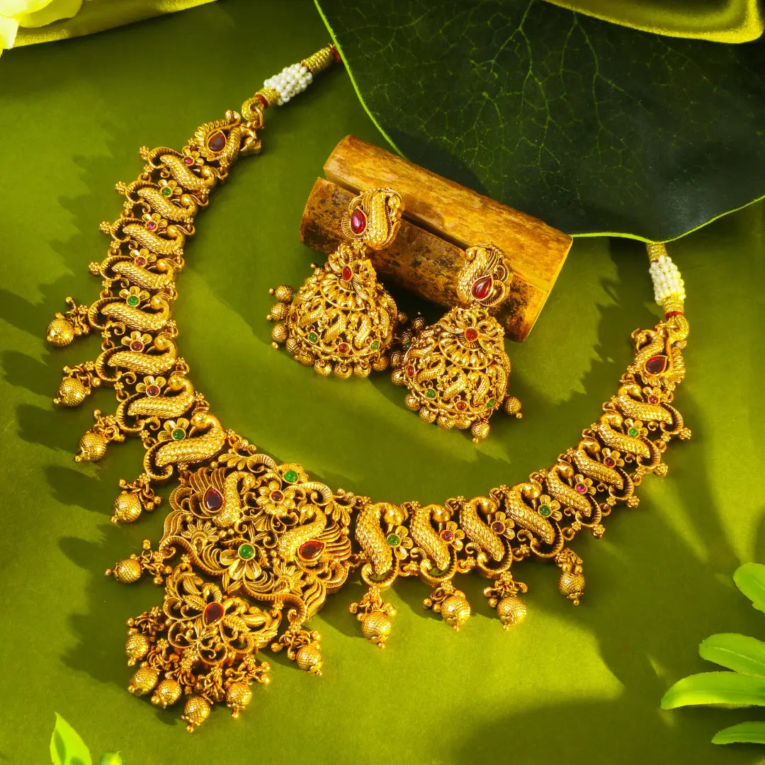 Peacock Temple Gold necklace Set on a green leaf Background